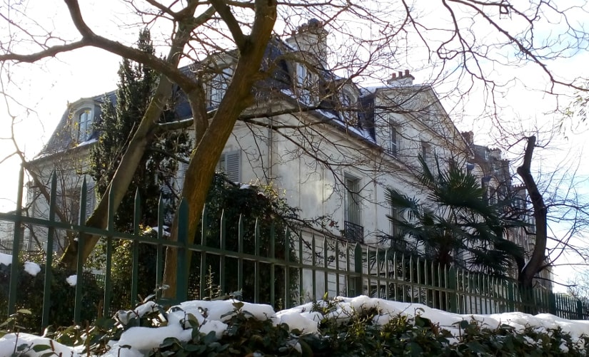 The Chateau des Brouillards Montmartre Allée des Bouillards Paris 75018. A large 18th century classical town house set in a small garden with trees. The scene is in winter with some snow.