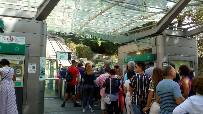 Tourists queueing for the funicular railway at the foot of Montmartre in summer.