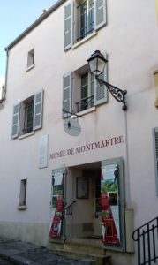 The oldest standing building in Montmartre houses the Montmartre Museum 12 Rue Cortot Paris 75018. The building features typical wooden Parisian shutters and a sign above the door proclaiming the Musee de Montmartre (Montmartre Museum)