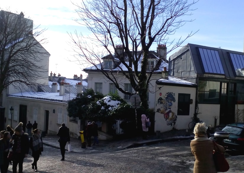 A general view of the Bateau Lavoir artists studios and workshops. The view is from Rue Ravignan looking west. Many tourists and visitors are visible.