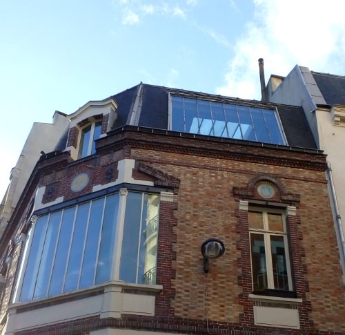 Detail of a building 7 Rue Tourlaque Paris 75018 showing a large window which forms the junction with rue Tourlaque. Toulouse Lautrec had a studio here in 1880s and 1890s.