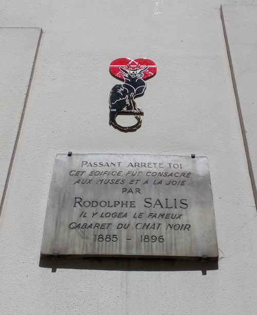 A plaque on the side of the building at 12 Rue Victor Massé Montmartre which housed the second Chat Noir (Black Cat) cabaret. The cabaret existed between 1885 – 1896. Above the plaque is a tile cut out representing the image of a black cat made famous by Théophile Steinlen in his advertising poster for the cabaret. The plaque says: “Passer-by, stop! This building was dedicated to the muses and to joy by Rodolphe Salis. It housed the famous Chat Noir cabaret 1885 – 1896.”