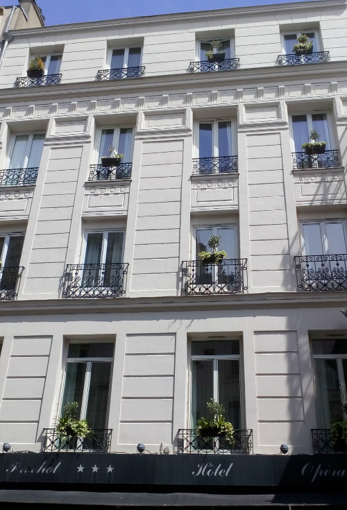 A view of a white painted four storey hotel facade at 4 Rue Frochot Montmartre. The building is now a hotel but used to be Degas’ apartment and studio in the mid 1870s.