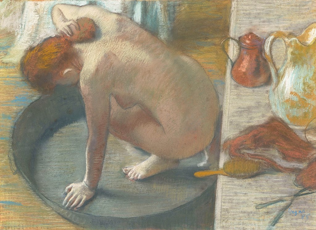 A woman with red hair is squatting naked in a shallow tub sponging the back of her neck. We see her in three-quarter back view. Behind her on a shelf are a scissors and comb and jugs for hot water.