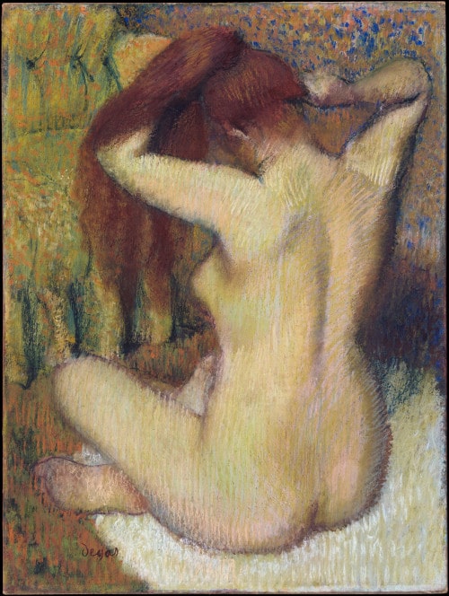 Degas’ Woman Combing Her Hair. A female bather figure dries her long auburn hair hair. We see a back three-quarter view. The work is executed in pastel with the contours of the bather’s back and hips designed in a light green over pink and white skin.